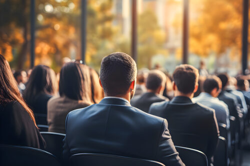 Business people sitting as an audience at a business convention